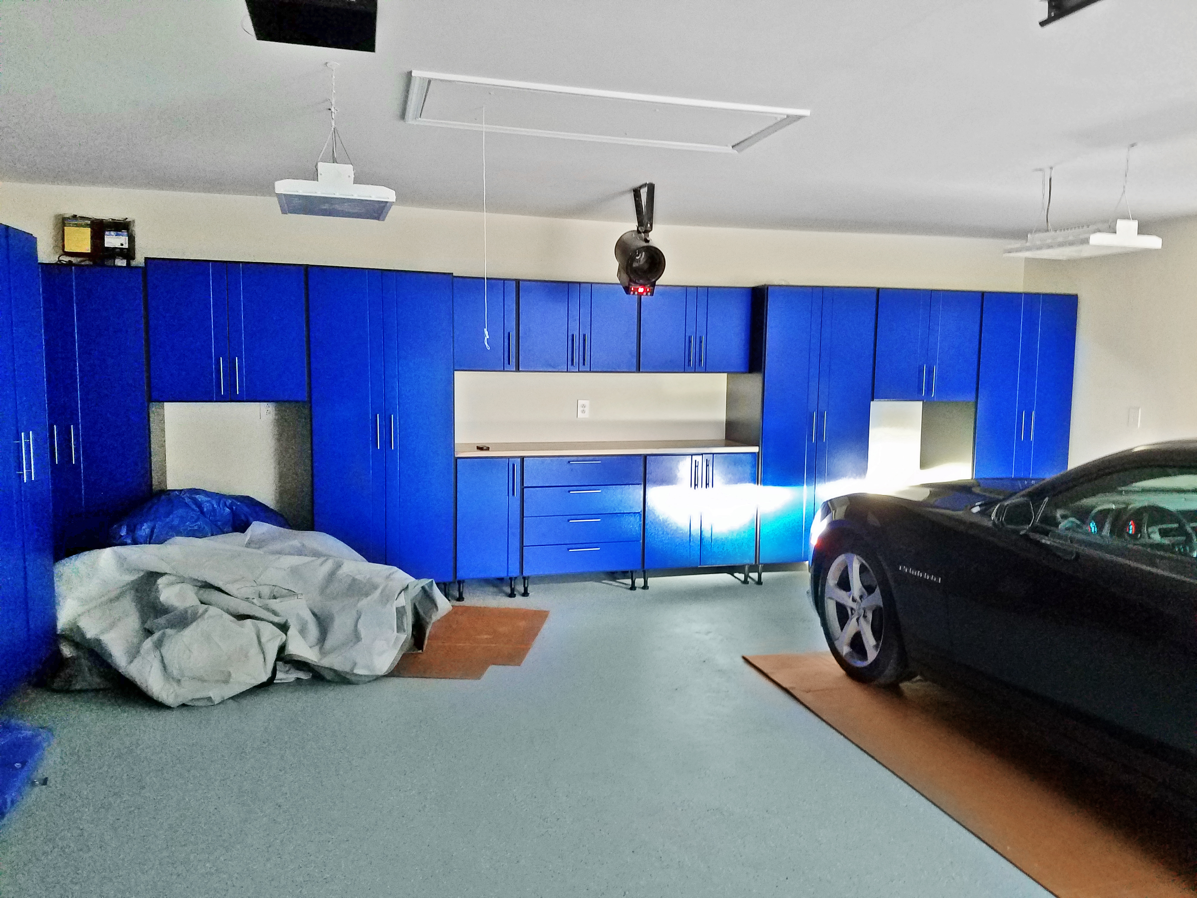 An array of cabinets solved Karen's storage issue and brightened her dismal garage.